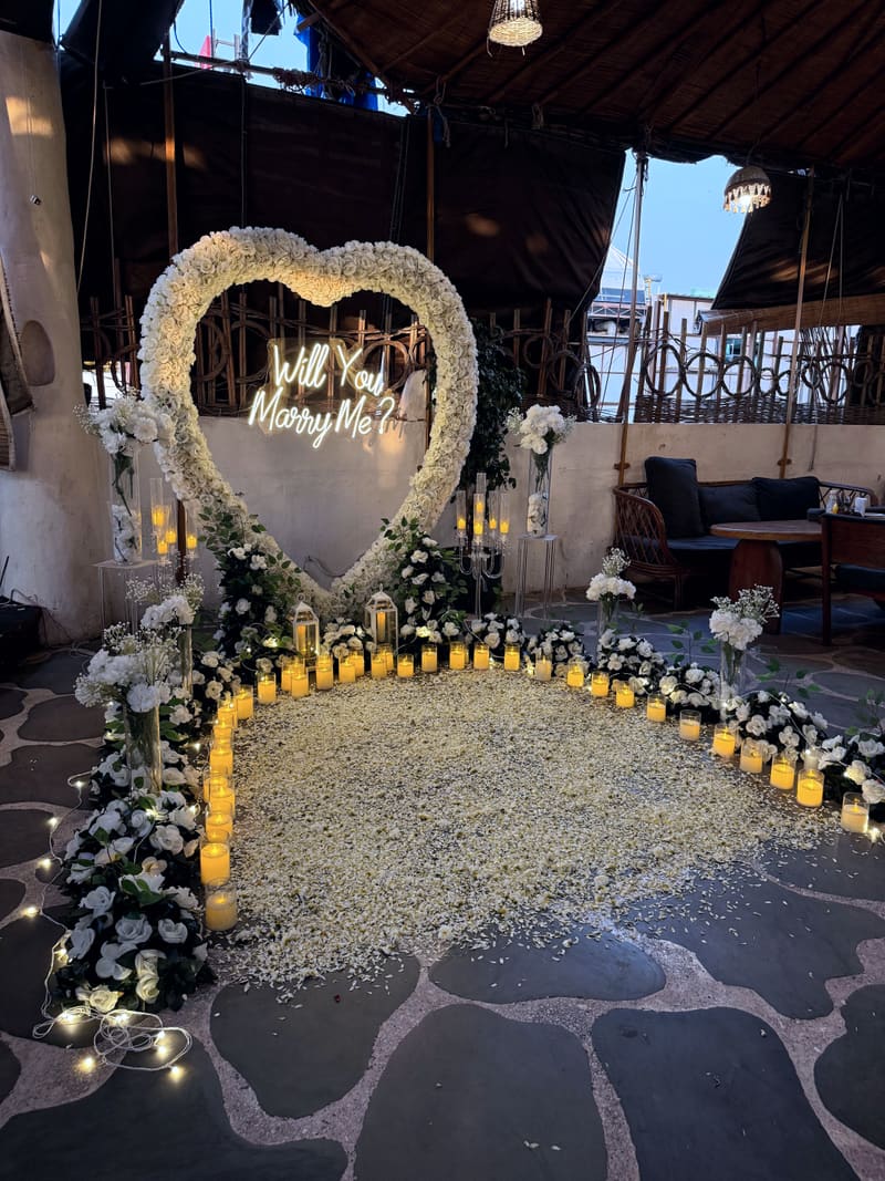 Proposal setup with candles and flowers by Cupid Vow, Chandigarh