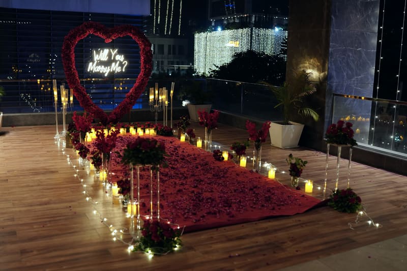 Proposal setup with candles and flowers by Cupid Vow, Chandigarh