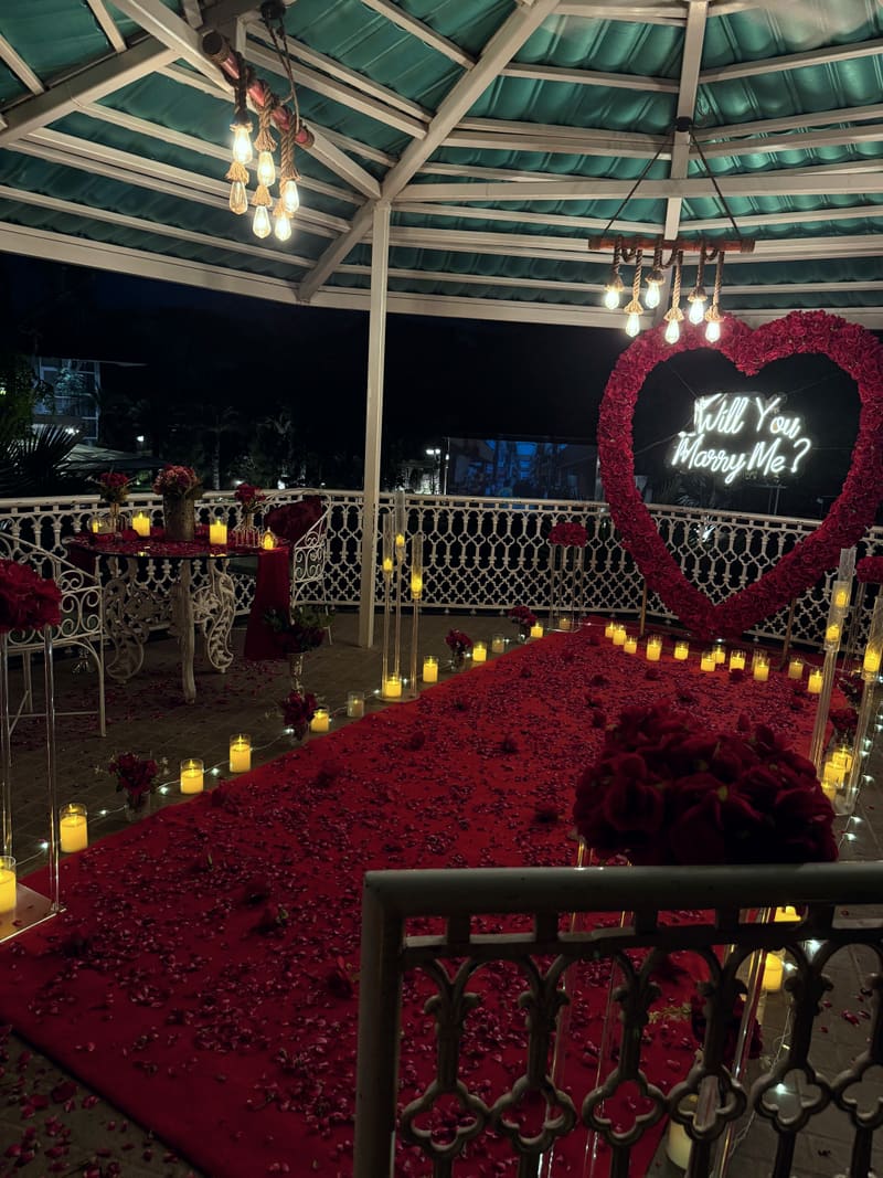 Proposal setup with candles and flowers by Cupid Vow, Chandigarh